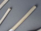three baseball bats and a bat that are on a table