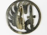 a metal pin with a knife in it on a white surface