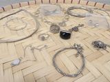 many different types of jewelry sitting on a basket