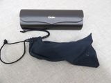 a black umbrella and a black case on the floor