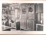 an old photo of a kitchen with a lot of cupboards