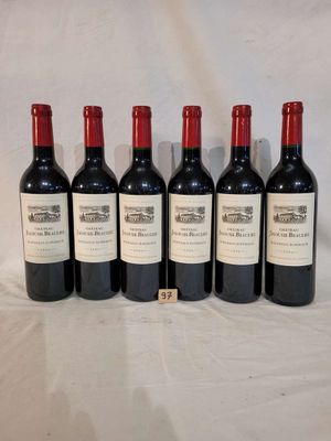 six bottles of red wine are lined up on a table