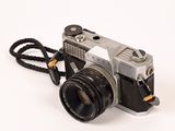 a silver camera with a black strap attached to it
