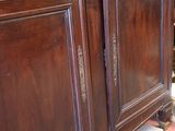 a wooden cabinet with a clock on top of it