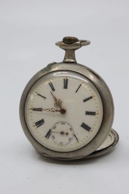 a silver pocket watch with roman numerals on the face