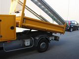 a yellow truck with a ladder on the back of it
