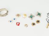a white table with a bunch of rings and glasses on it