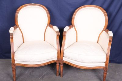 pair of antique french style chairs with white upholstered cushions