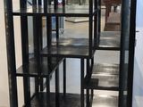 a glass display case with black shelves in a room