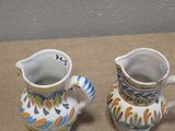 two vases that are sitting on a table
