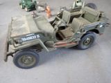a toy army jeep with a trailer attached to the back of it