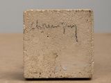 a small piece of concrete with writing on it