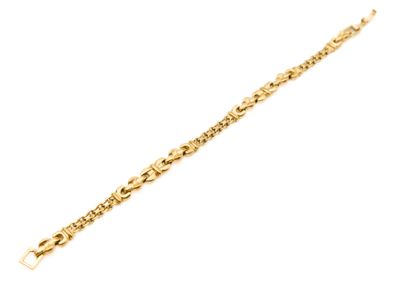 a close up of a gold bracelet on a white background