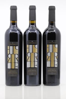 three bottles of wine sitting next to each other on a white surface
