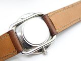 a close up of a watch on a white surface