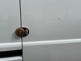 a close up of a door handle on a white van