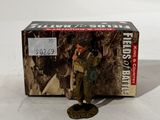 the toy soldier is standing in front of a box of toys