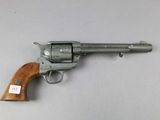 a close up of a revolver on a table with a tag on it