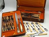 many different types of knives and spoons in a case