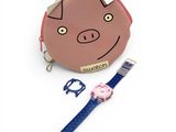 a pink coin purse with a pig face on it and a toothbrush