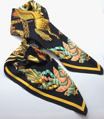 a black and yellow scarf with a bird design on it
