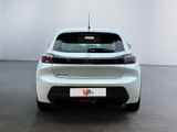 the rear end of a white car in a room with a white wall