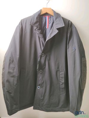 jacket hanging on a hanger on a wall in a room