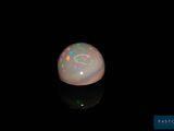 an image of a white oplite on a black surface