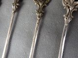 three spoons that are sitting on a table