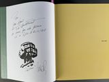 an open book with a drawing of a man in a cage on it