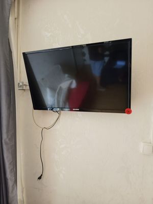 a flat screen tv mounted on a wall in a room