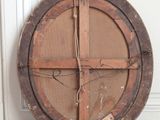 a wooden circular object on the floor near a door