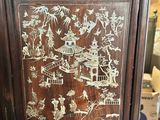 a cabinet that has a lot of asian designs on it