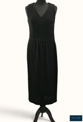 La robe est noire et présente un décolleté en V.