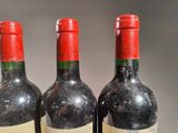three bottles of wine sitting next to each other on a table