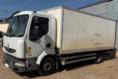 a white truck parked in front of a building