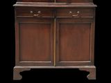 an old wooden cabinet with two drawers and two doors