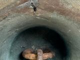 a large metal bell with a wooden handle in it