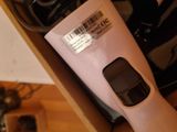 a pink hair dryer sitting in a box on a table