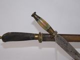 a close up of a knife and a knife holder on a table