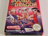 the box of the game double dragon is sitting on a white surface