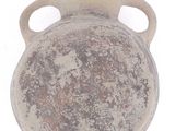 an old vase that is sitting on a white surface
