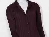 an image of a mannequin mannequin wearing a brown shirt and black pants