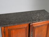 a black granite top on a wooden cabinet in a room