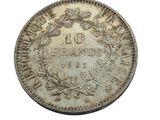 an old silver coin with a wreath on top of it