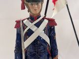 statue of a toy soldier with a british flag on a white background