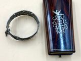 a lighter that is sitting on a table next to a bracelet