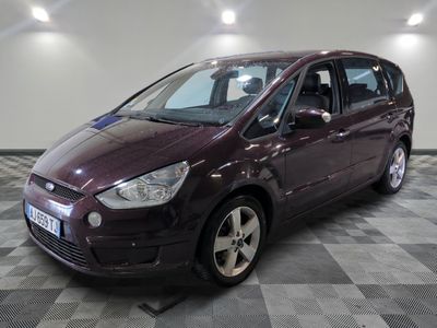 a picture of a maroon ford c - max parked on a checkered floor
