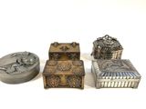 three silver metal boxes sitting next to each other on a white surface