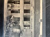 a black and white photo of a postcard of a building